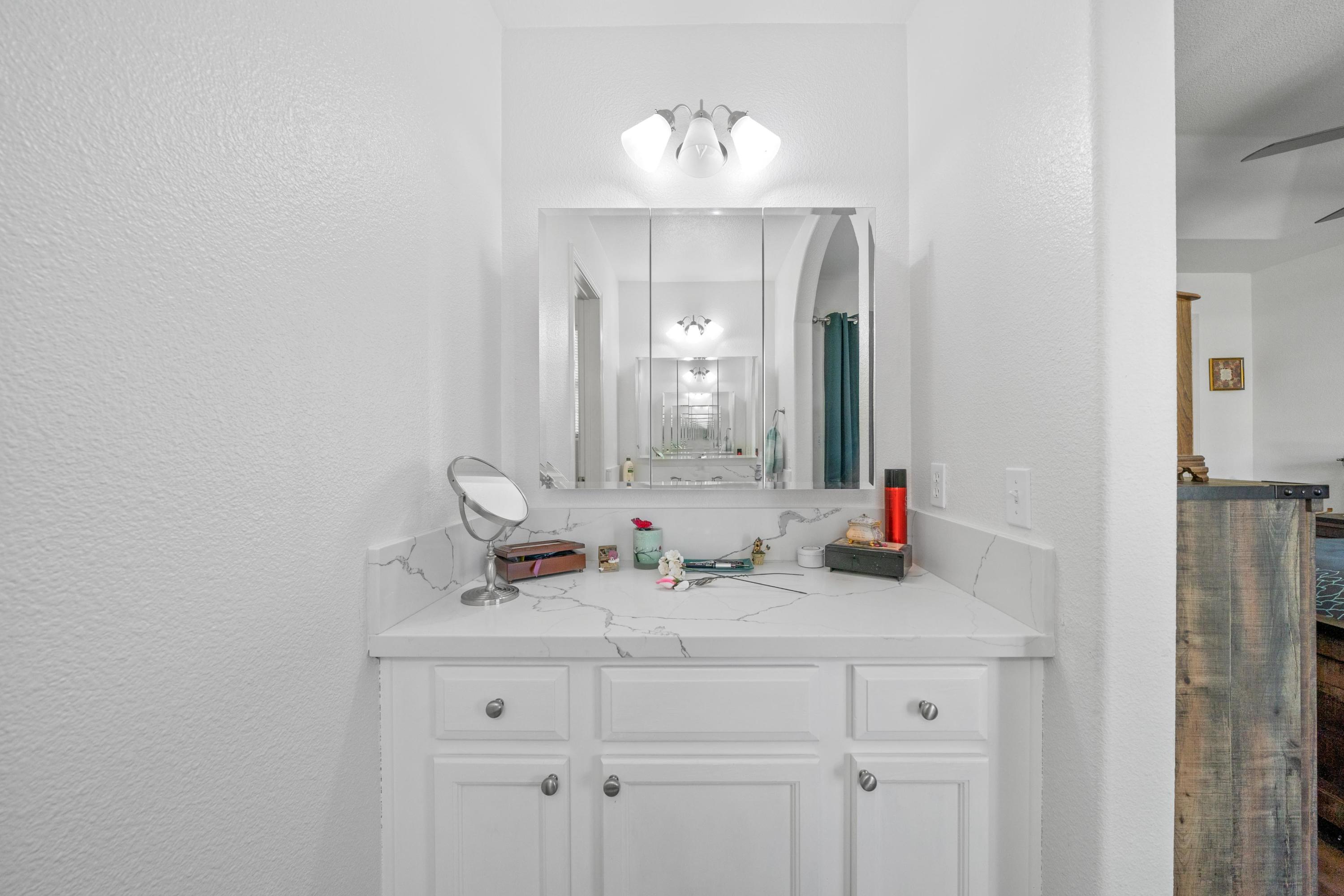 775 Stonebriar Trail Redding, CA 96003 - Photo 14 of 32 a bathroom with double vanity sink and a mirror
