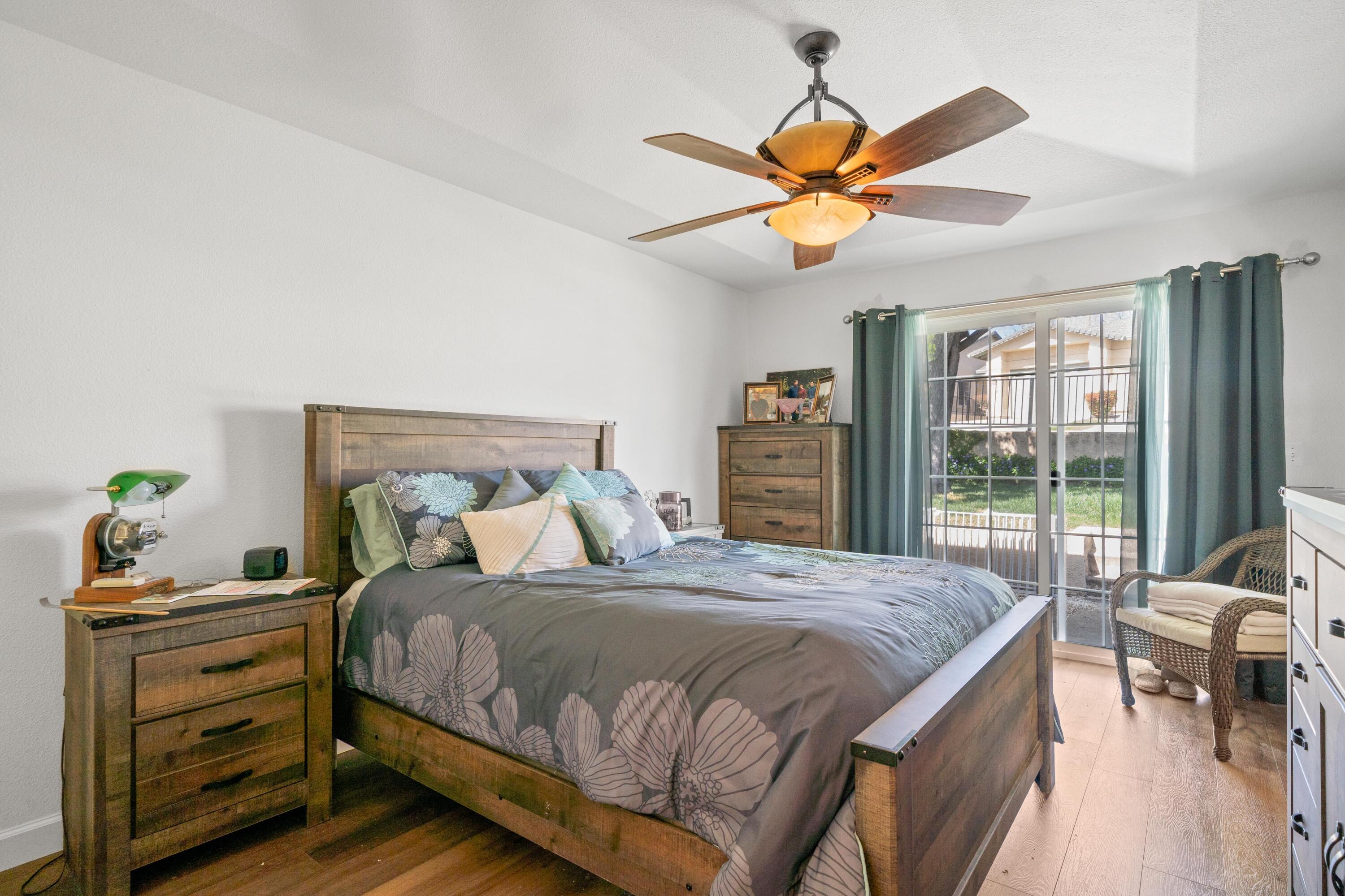775 Stonebriar Trail Redding, CA 96003 - Photo 15 of 32 a bedroom with a bed and a chandelier