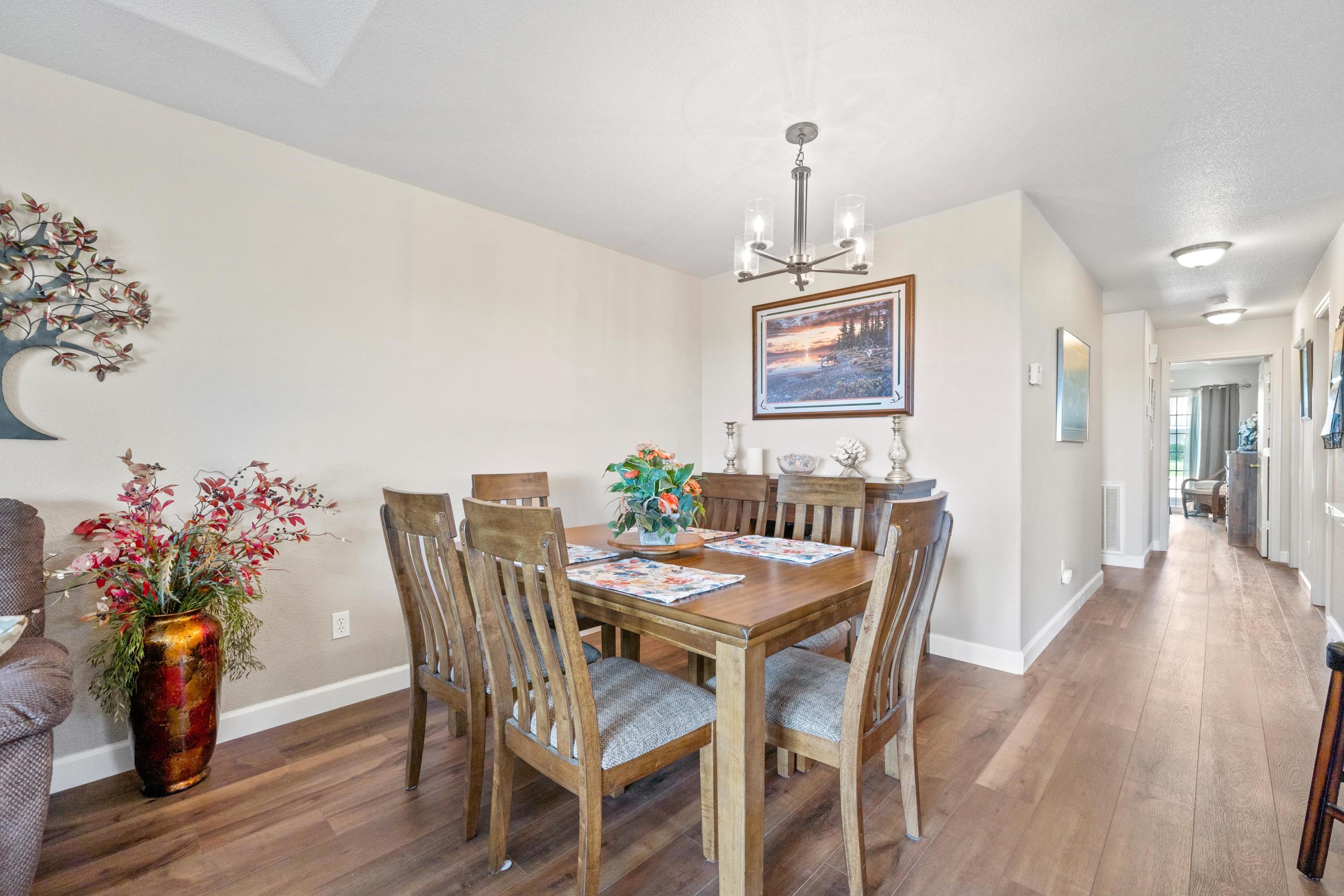775 Stonebriar Trail Redding, CA 96003 - Photo 4 of 32 a view of a dining room with furniture and wooden floor