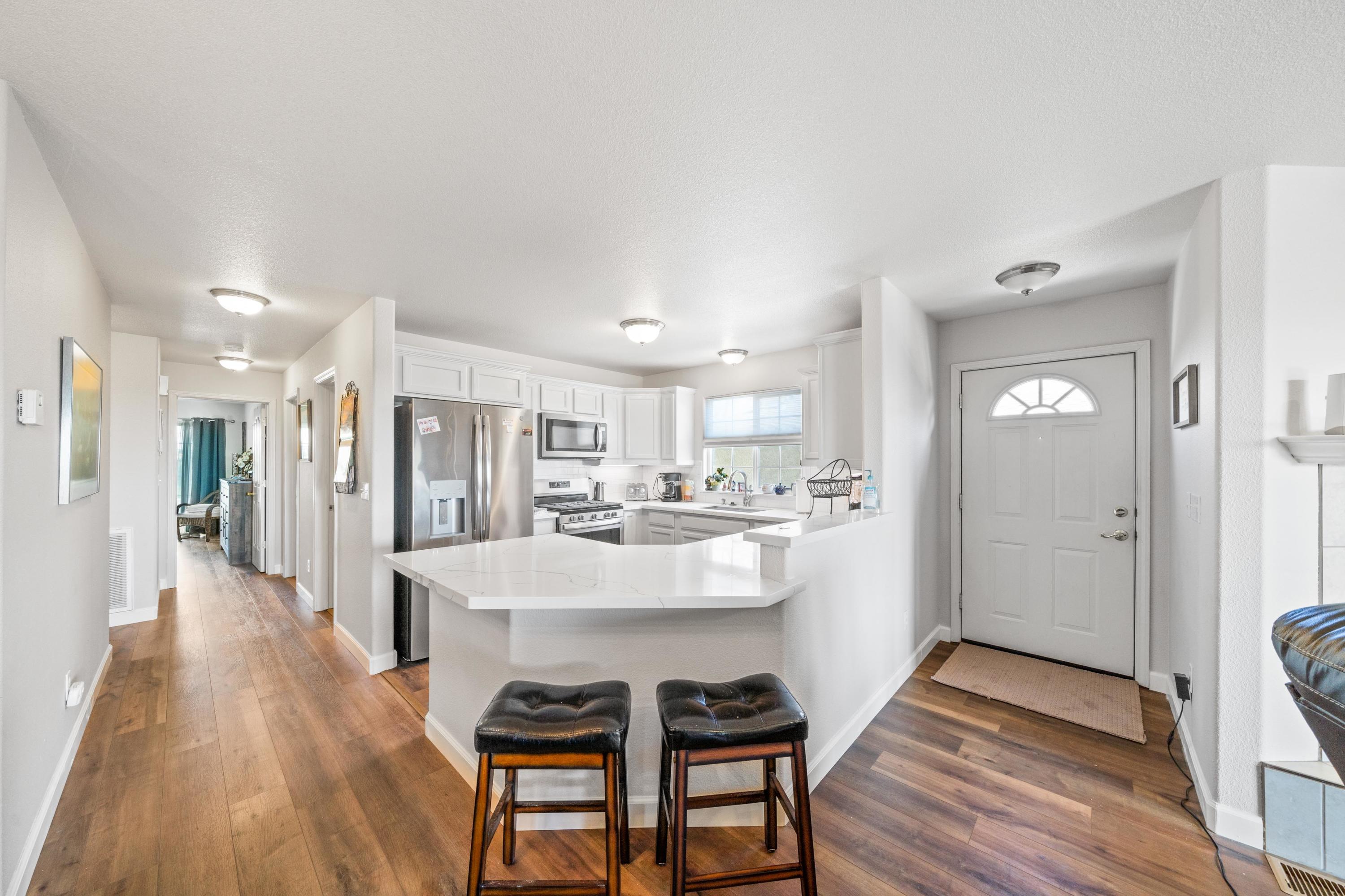 775 Stonebriar Trail Redding, CA 96003 - Photo 10 of 32 a view of a dining room kitchen with furniture and wooden floor