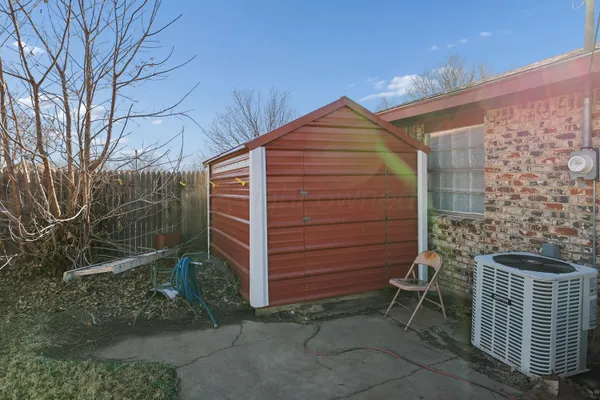 a backyard of a house with lots of green space and bench
