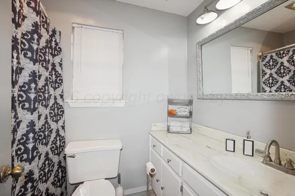 a bathroom with a sink toilet vanity and tub