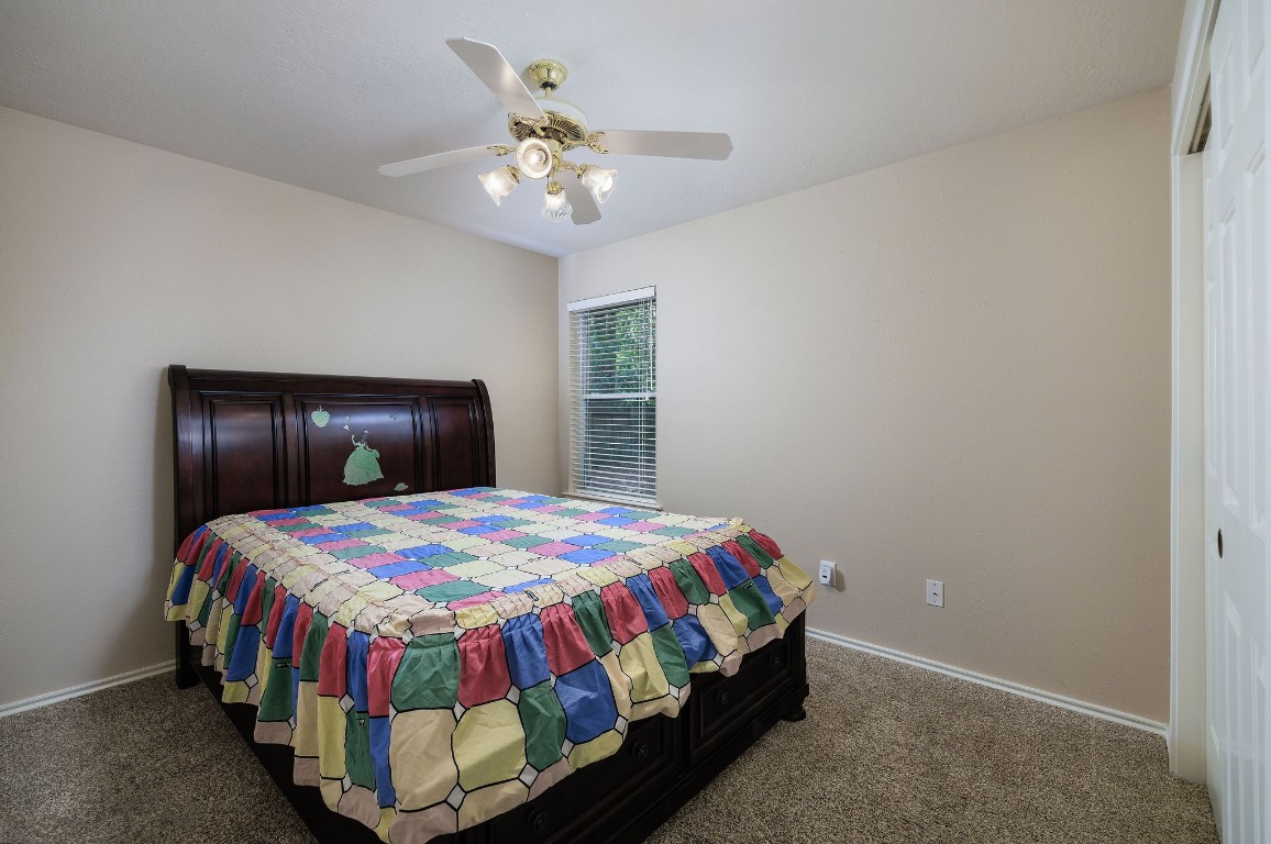 18 Tallow Hill Place Spring, TX 77382 - Photo 13 of 21 a bedroom with a bed and a chandelier