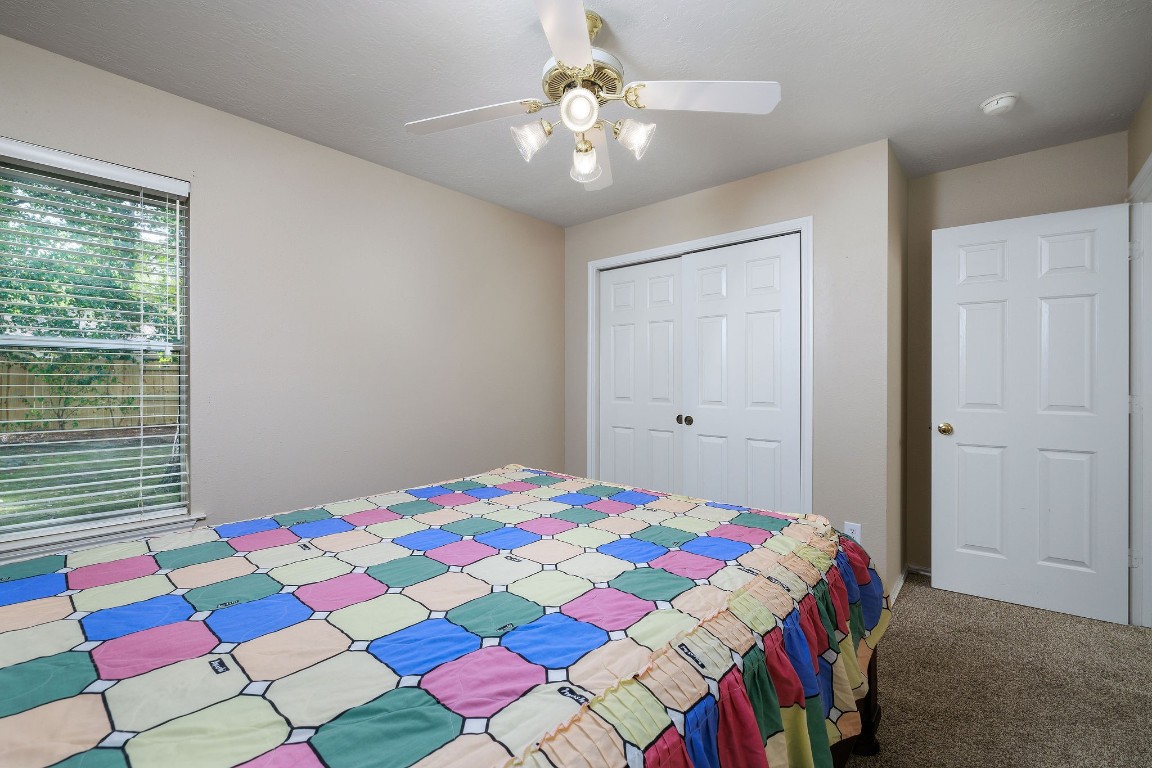 18 Tallow Hill Place Spring, TX 77382 - Photo 14 of 21 a bedroom with a bed and a chandelier