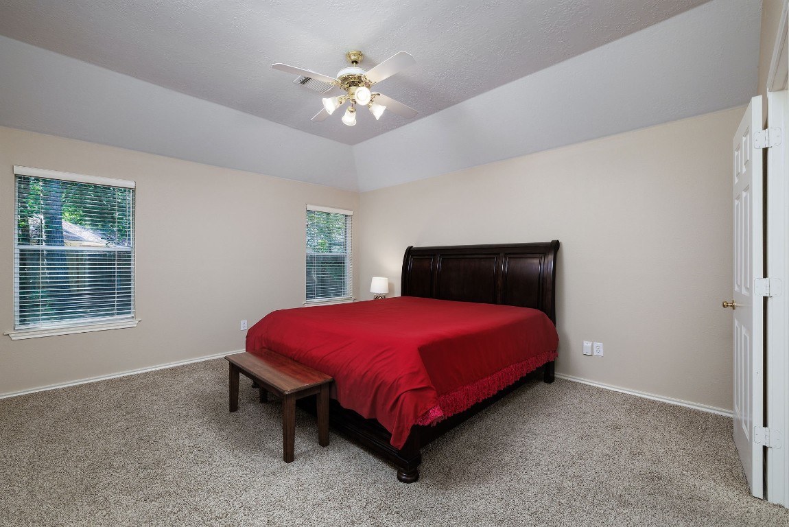 18 Tallow Hill Place Spring, TX 77382 - Photo 9 of 21 a bed sitting in a bedroom next to a window