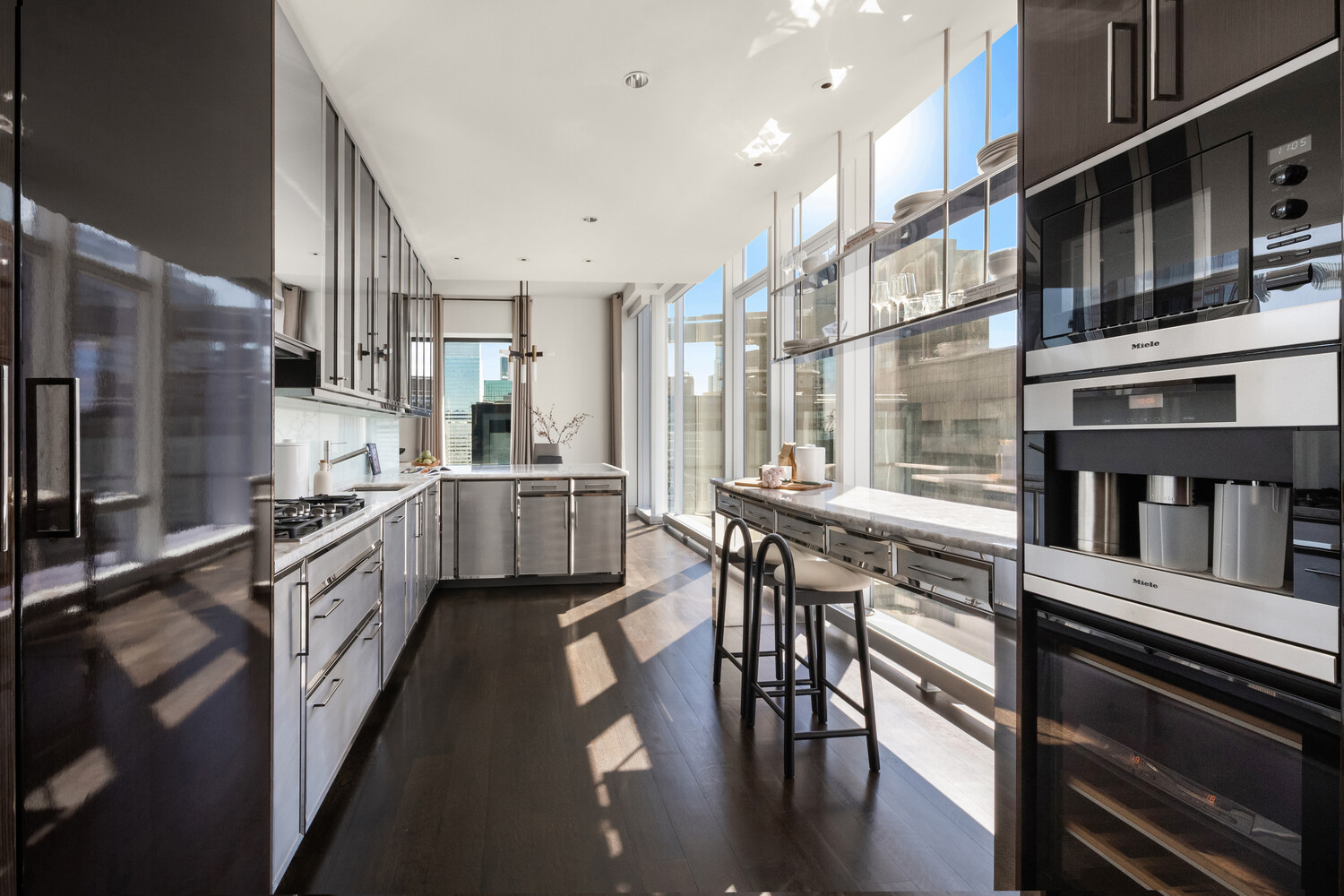 20 West 53rd Street, Unit PH43 Manhattan, NY 10019 - Photo 5 of 14 a kitchen with stainless steel appliances granite countertop lots of counter top space and furniture