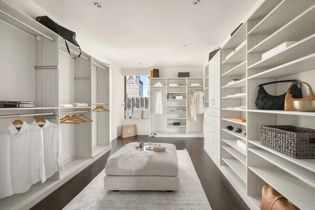 a bedroom with bed and a large window with balcony view