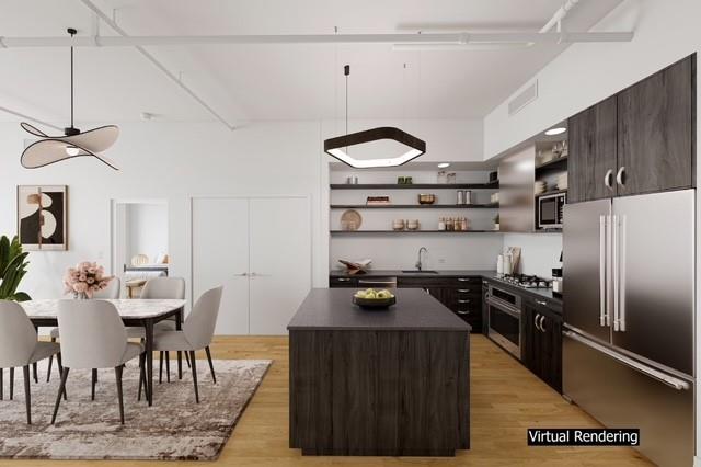 50 Pine Street, Unit 4N Manhattan, NY 10005 - Photo 2 of 8 a kitchen with stainless steel appliances granite countertop a stove refrigerator and cabinets