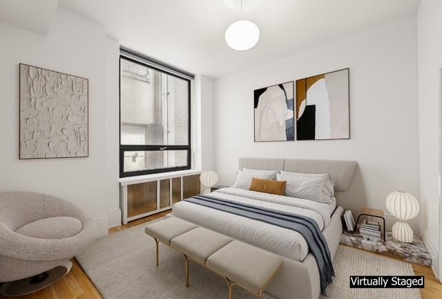 50 Pine Street, Unit 4N Manhattan, NY 10005 - Photo 3 of 8 a bedroom with a bed and a painting on the wall