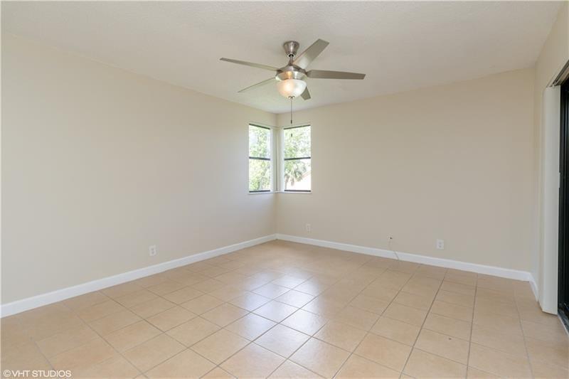 5641 Riverside Drive, Unit 202B1 Coral Springs, FL 33067 - Photo 6 of 14 an empty room with a window and a chandelier fan