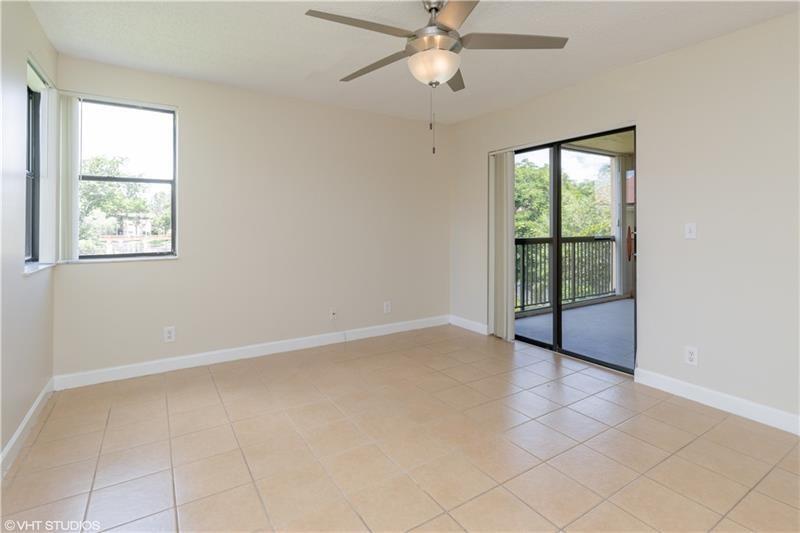 5641 Riverside Drive, Unit 202B1 Coral Springs, FL 33067 - Photo 7 of 14 an empty room with windows and fan