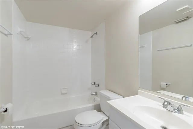 a front view of a residential apartment building with a yard