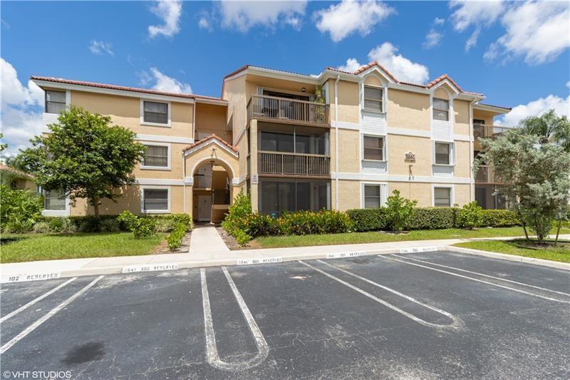 5641 Riverside Drive, Unit 202B1 Coral Springs, FL 33067 - Photo 10 of 14 a front view of a residential apartment building with a yard
