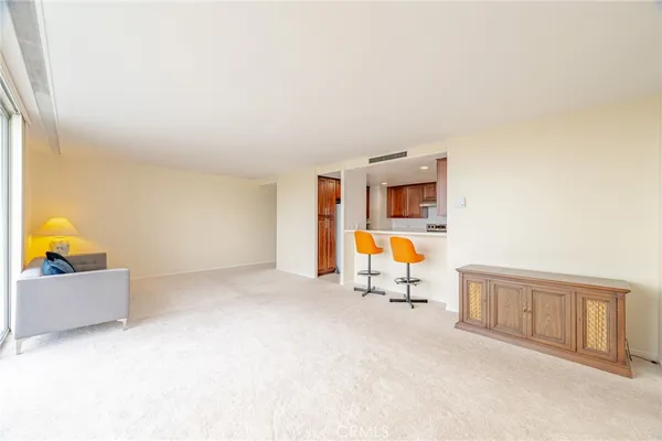 a kitchen with stainless steel appliances granite countertop wooden cabinets a sink and dishwasher a stove top oven with wooden floor