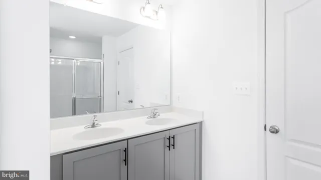 a bathroom with a sink a light fixture and a vanity