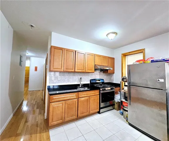 a kitchen with a sink appliances and cabinets