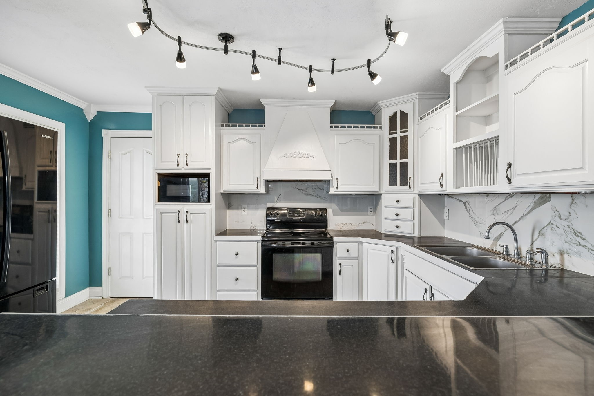 6701 McCormick Ridge Road Whitleyville, TN 38588 - Photo 17 of 63 a kitchen with stainless steel appliances granite countertop a sink a stove and refrigerator