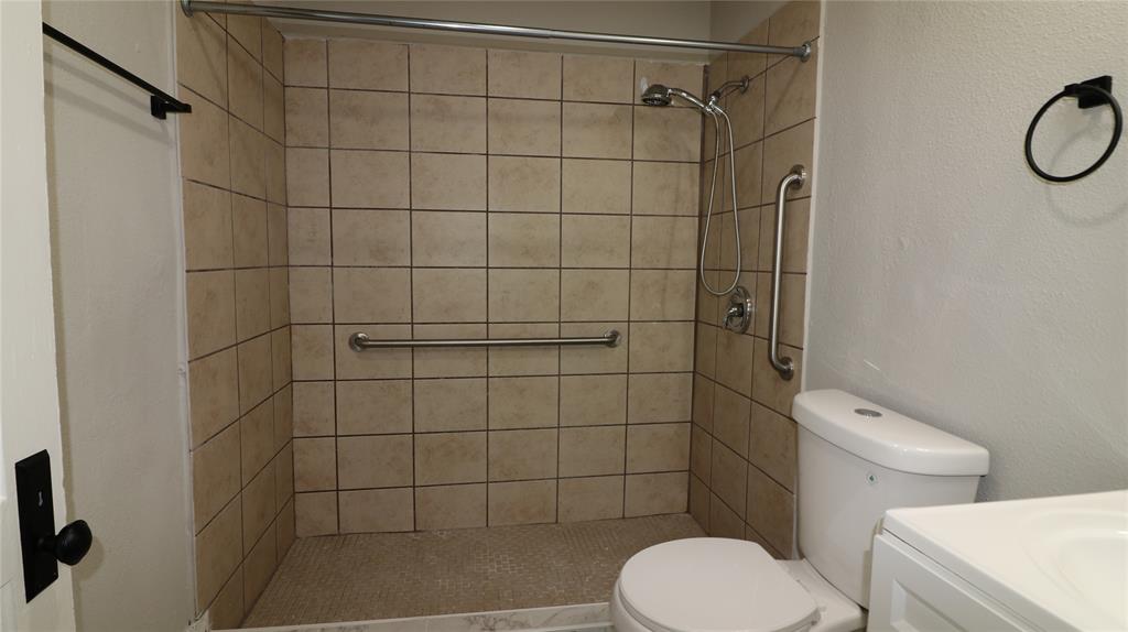 929 Vitalious Street Ranger, TX 76470 - Photo 17 of 22 Bathroom with a shower stall, vanity, and a textured wall