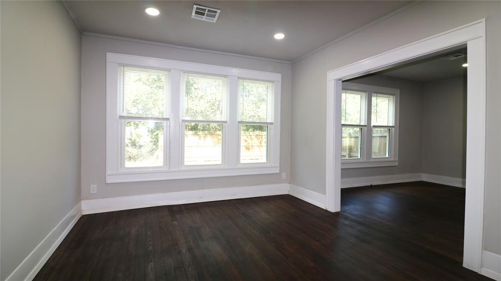 929 Vitalious Street Ranger, TX 76470 - Photo 7 of 22 Spare room featuring dark wood finished floors, crown molding, and recessed lighting