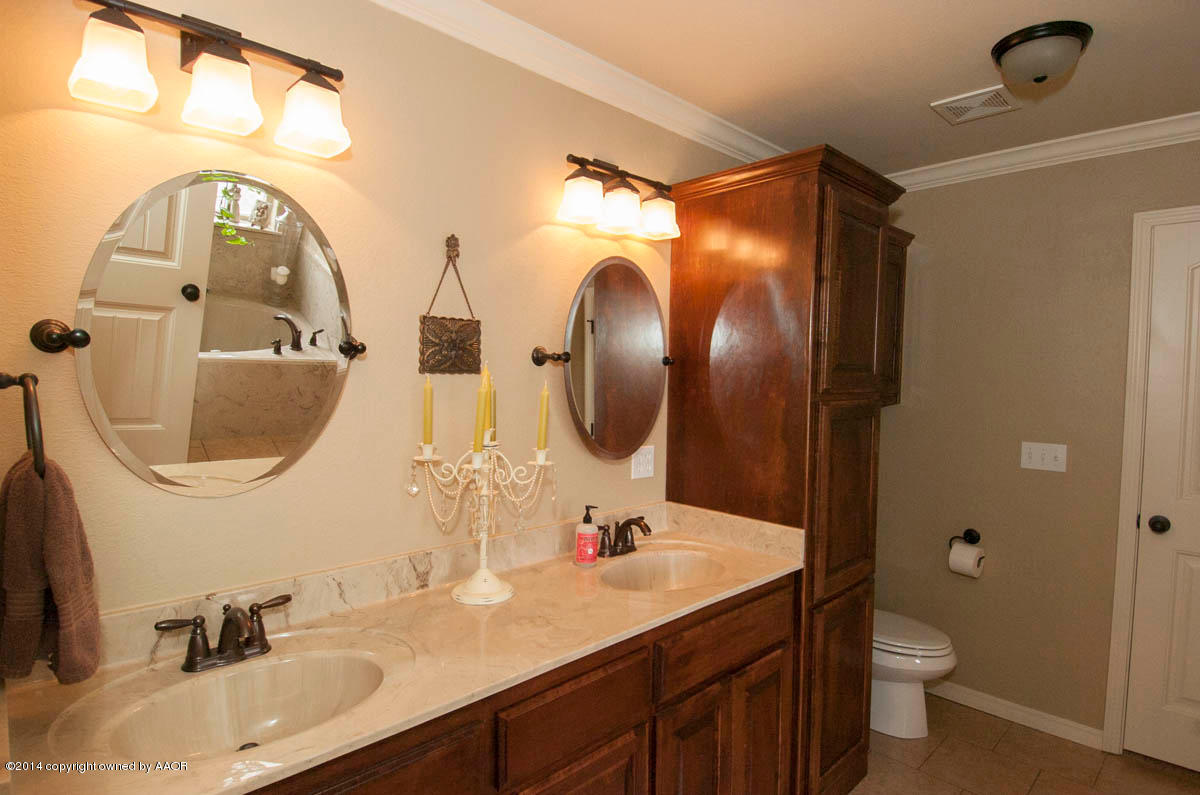 18301 Copper Ridge Bushland, TX 79124 - Photo 17 of 38 a bathroom with a double vanity sink mirror and toilet
