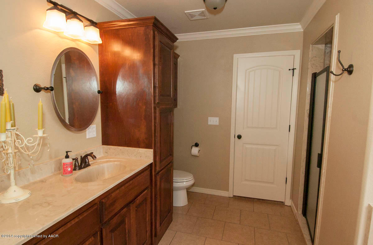 18301 Copper Ridge Bushland, TX 79124 - Photo 18 of 38 a bathroom with a granite countertop sink a toilet and a mirror