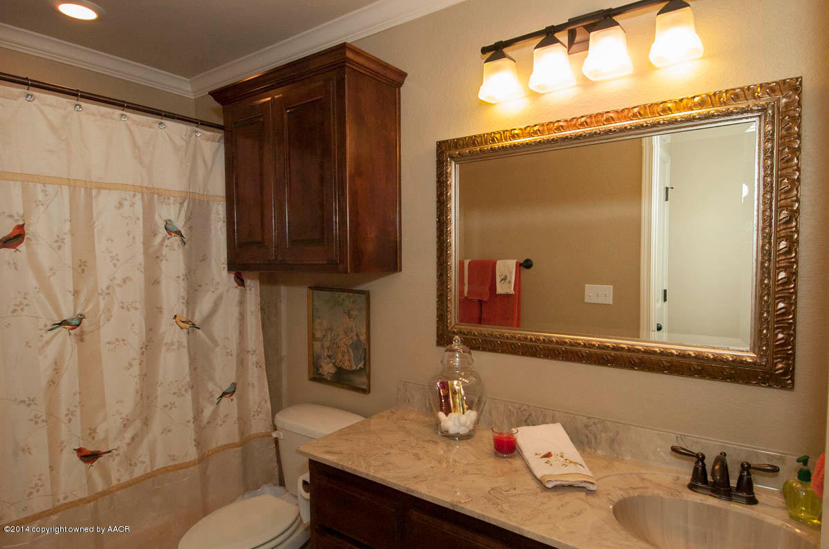 18301 Copper Ridge Bushland, TX 79124 - Photo 23 of 38 a bathroom with a granite countertop sink toilet and shower