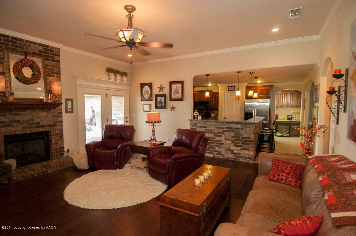 18301 Copper Ridge Bushland, TX 79124 - Photo 3 of 38 a living room with furniture a fireplace and a chandelier