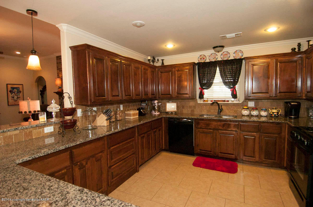 18301 Copper Ridge Bushland, TX 79124 - Photo 7 of 38 a kitchen with stainless steel appliances granite countertop a sink stove and refrigerator