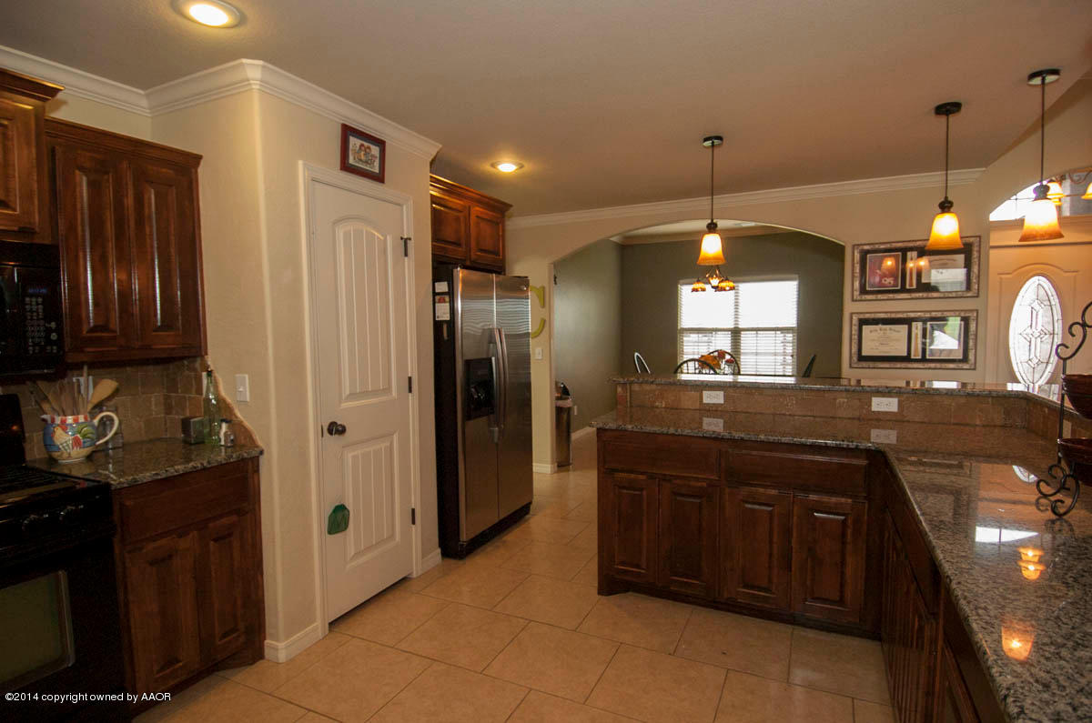 18301 Copper Ridge Bushland, TX 79124 - Photo 9 of 38 a kitchen with a sink and refrigerator