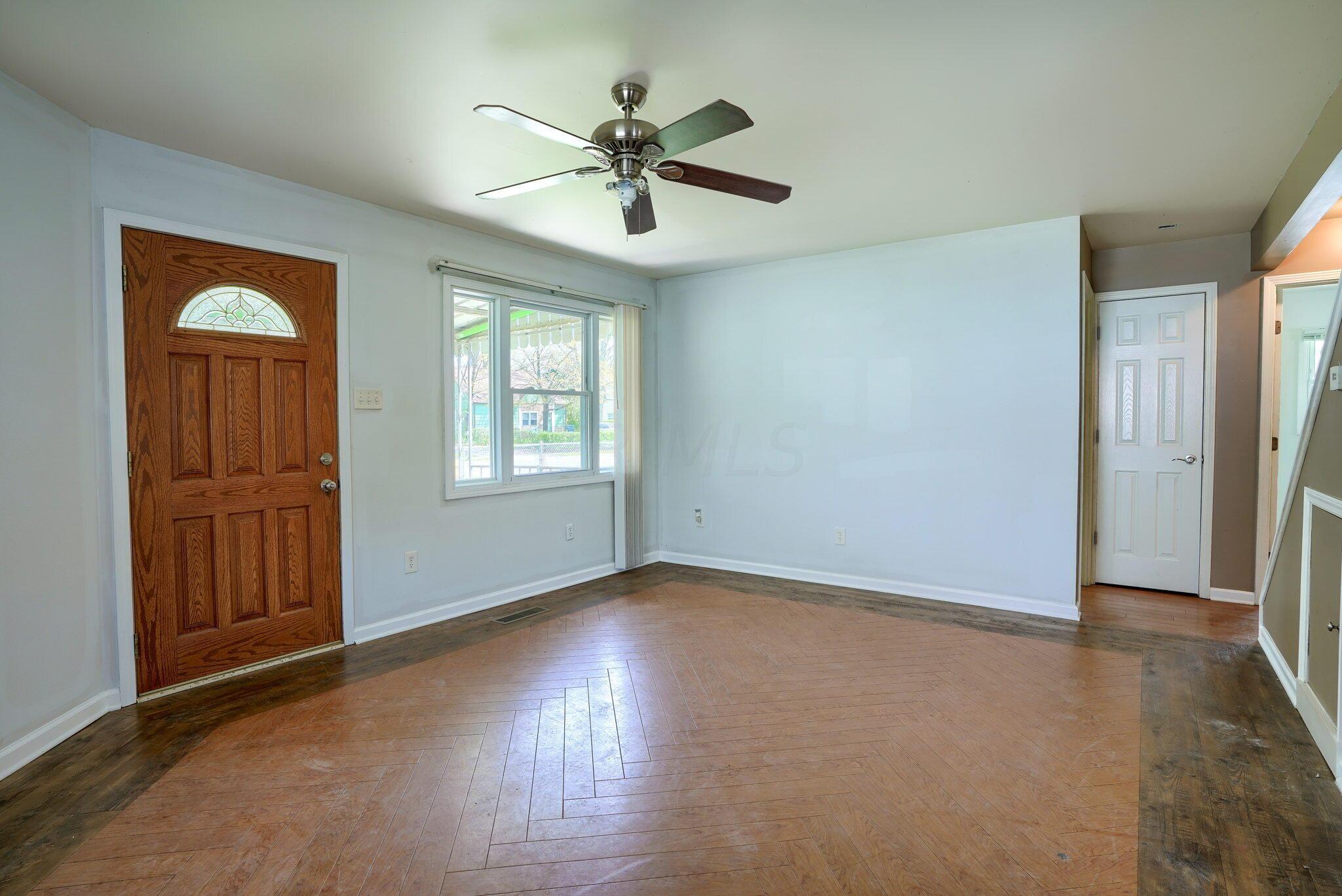 909 Exeter Road Columbus, OH 43213 - Photo 9 of 38 Living room floor features a custom herringbone laminate.