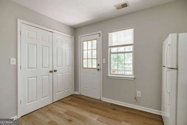 a kitchen with granite countertop white cabinets and white appliances
