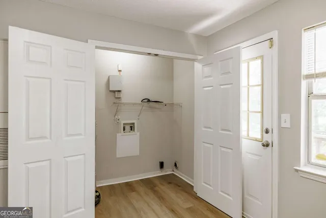 a view of an empty room and chandelier fan