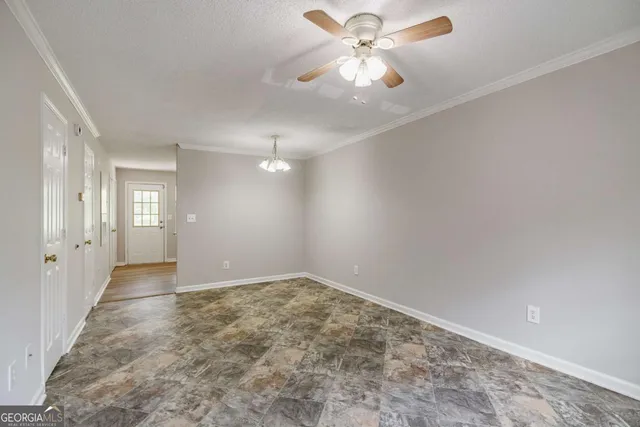 a view of a kitchen with sink and refrigerator