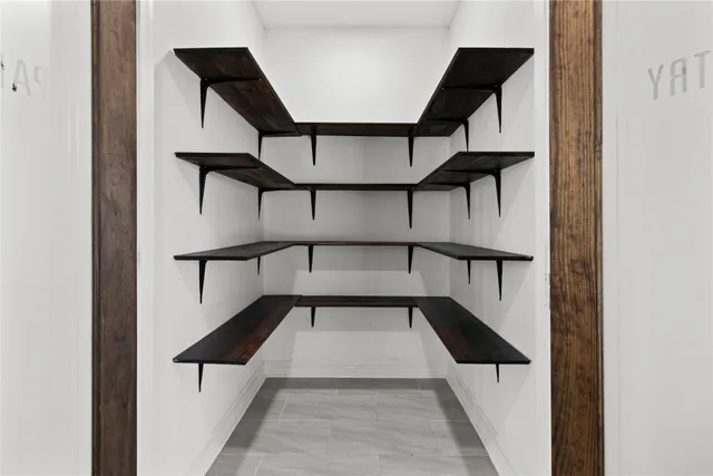 a kitchen with stainless steel appliances granite countertop a stove a refrigerator and a wooden floors