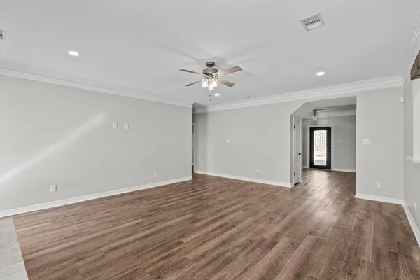 a kitchen that has a sink a stove and wooden floor