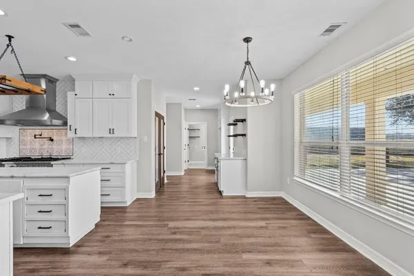 a kitchen that has a lot of cabinets in it