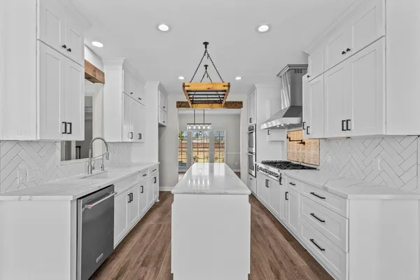 a kitchen with stainless steel appliances granite countertop a stove and a microwave