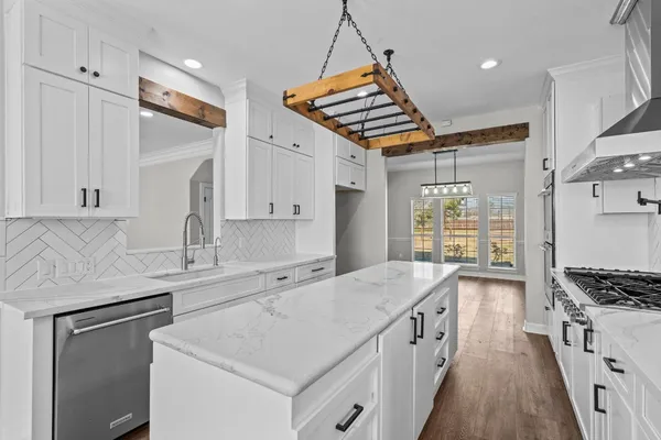 a bathroom with a granite countertop sink a mirror and a shower