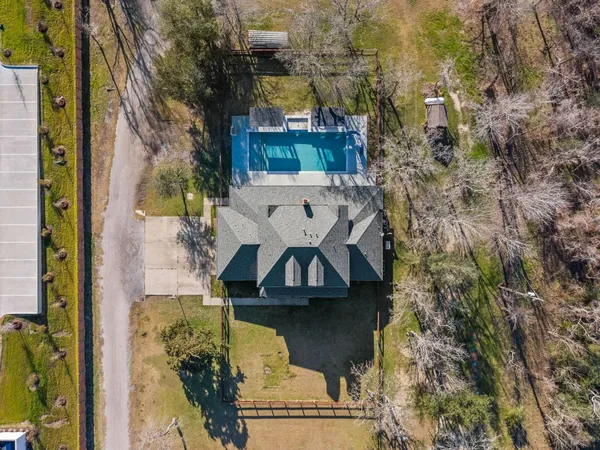 a front view of house with yard and ocean