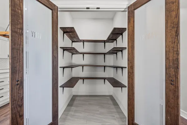 an empty room with wooden floor ceiling fan and windows