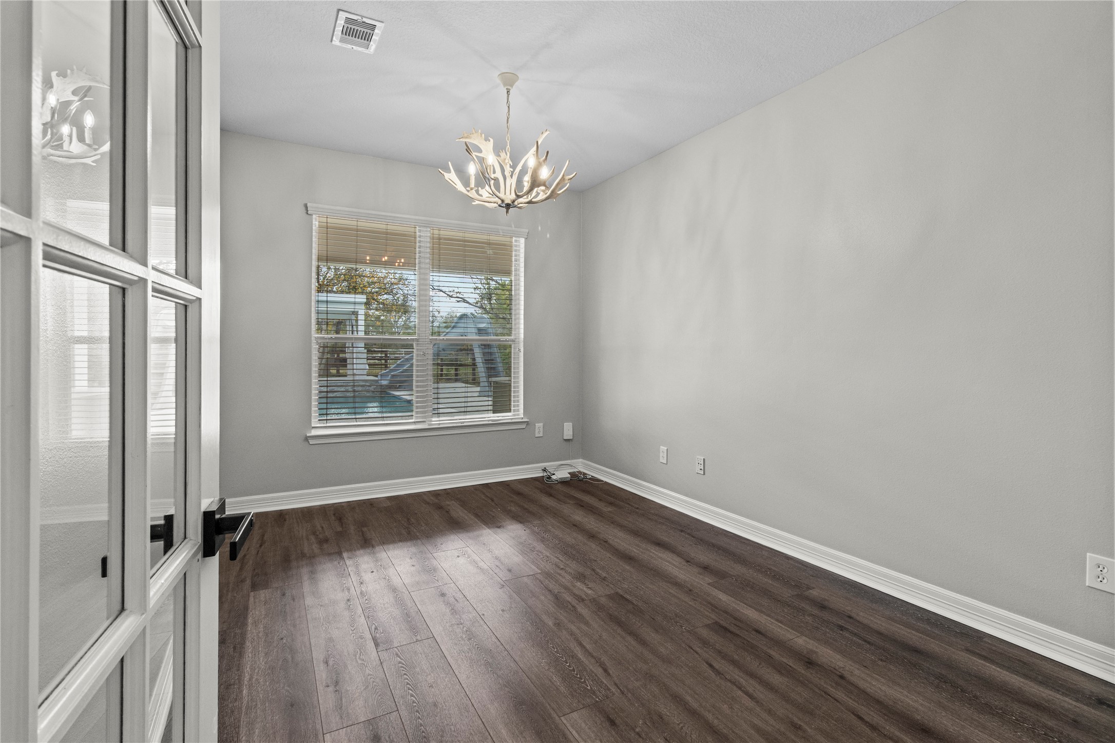 2730 Lawrence Road Kemah, TX 77565 - Photo 30 of 48 a view of an empty room with wooden floor and a window