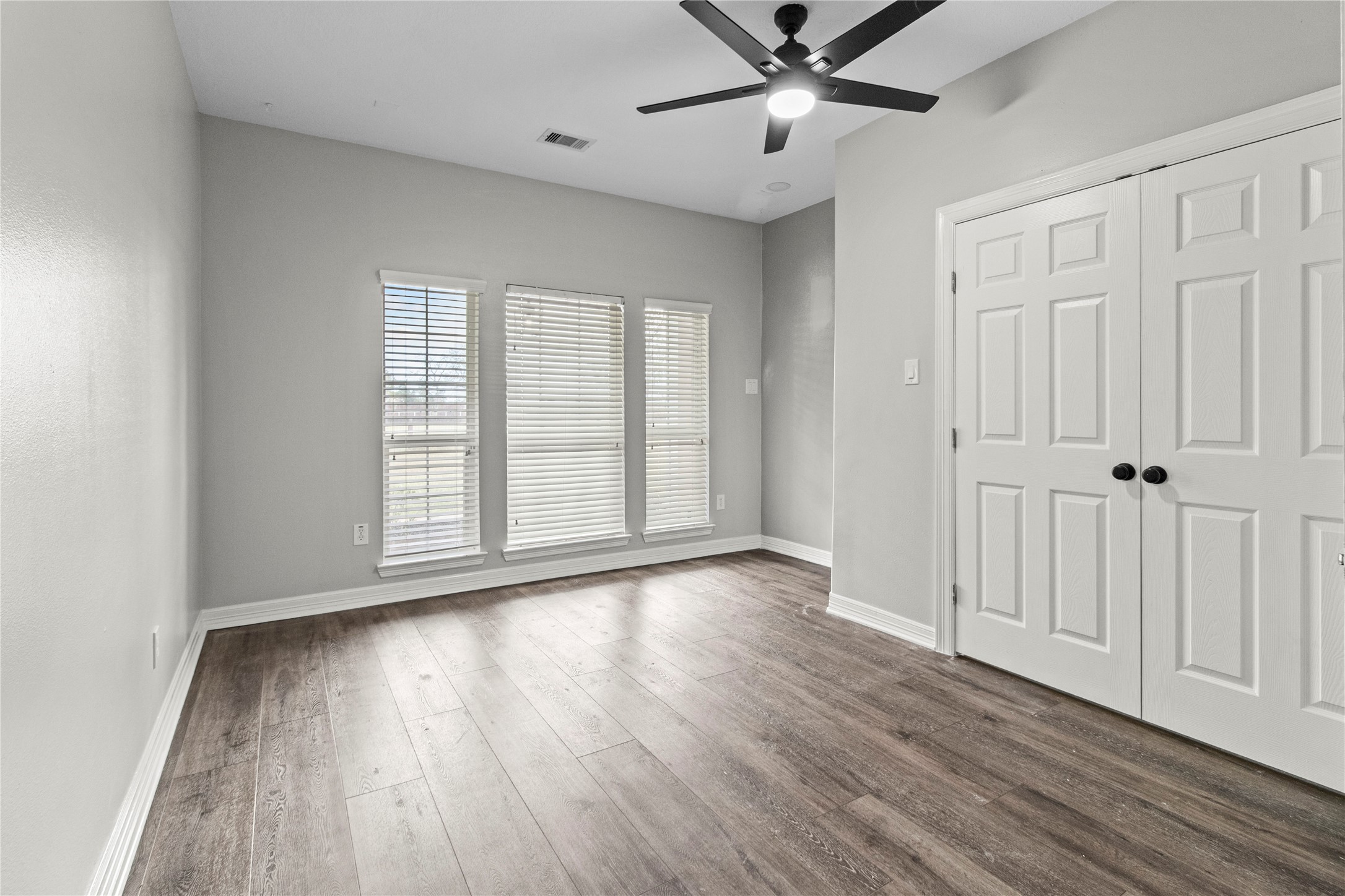 2730 Lawrence Road Kemah, TX 77565 - Photo 31 of 48 an empty room with wooden floor fan and windows