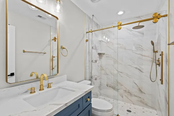a kitchen with stainless steel appliances granite countertop a sink a stove and a refrigerator