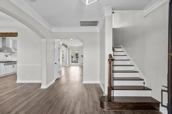 a view of empty room with wooden floor and window