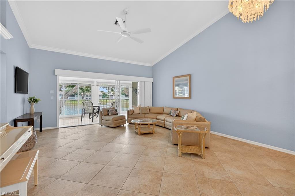 13061 Hamilton Harbour Drive, Unit R5 Naples, FL 34110 - Photo 12 of 39 a living room with furniture and a flat screen tv