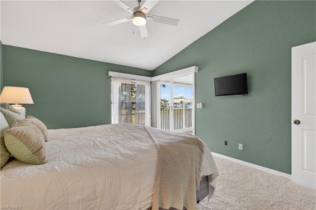 13061 Hamilton Harbour Drive, Unit R5 Naples, FL 34110 - Photo 19 of 39 a bedroom with a large bed and a flat tv screen