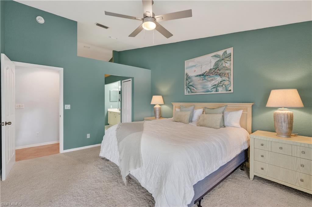 13061 Hamilton Harbour Drive, Unit R5 Naples, FL 34110 - Photo 20 of 39 a bedroom with a bed and a painting on the wall
