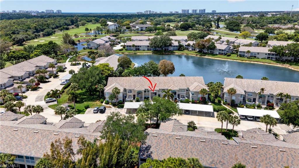 13061 Hamilton Harbour Drive, Unit R5 Naples, FL 34110 - Photo 2 of 39 an aerial view of a house with a lake view
