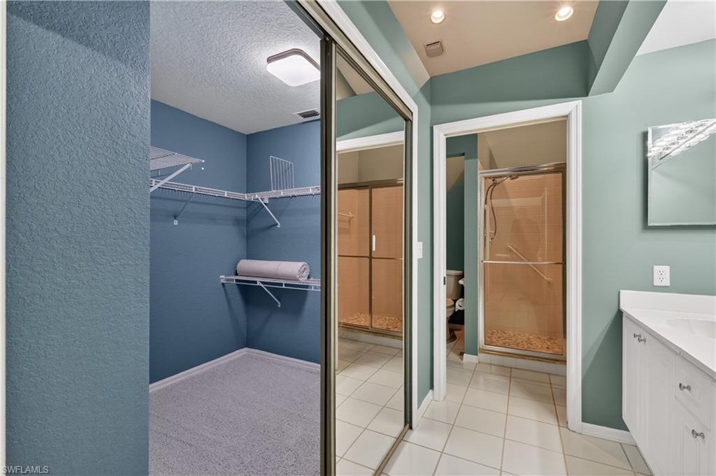 13061 Hamilton Harbour Drive, Unit R5 Naples, FL 34110 - Photo 22 of 39 a bathroom with a sink a toilet and shower