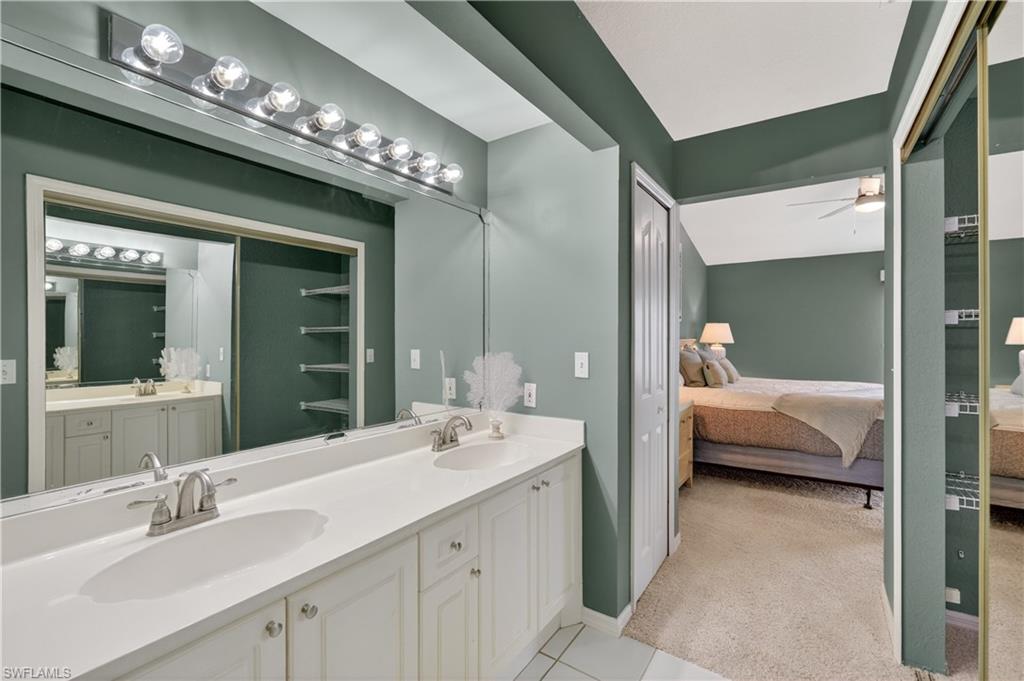 13061 Hamilton Harbour Drive, Unit R5 Naples, FL 34110 - Photo 26 of 39 a en suite bathroom with a double vanity sink and a mirror
